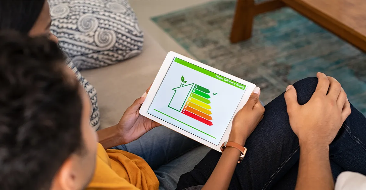 People are looking at a chart on their ipad showing energy efficient homeupgrade options
