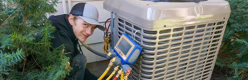 a heat pump technician smiles