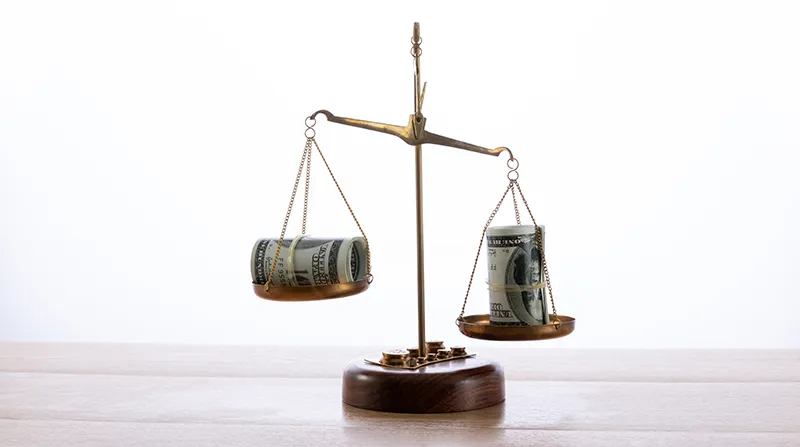 A scale balancing money representing return on investment