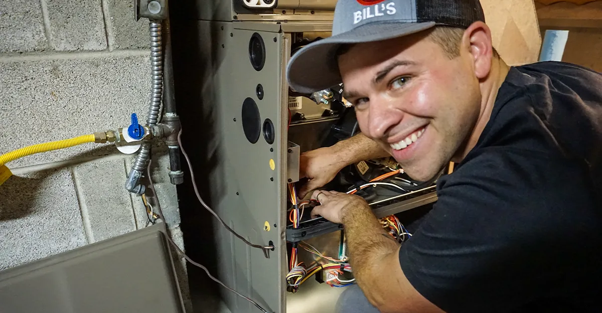 a furnace technician smiles