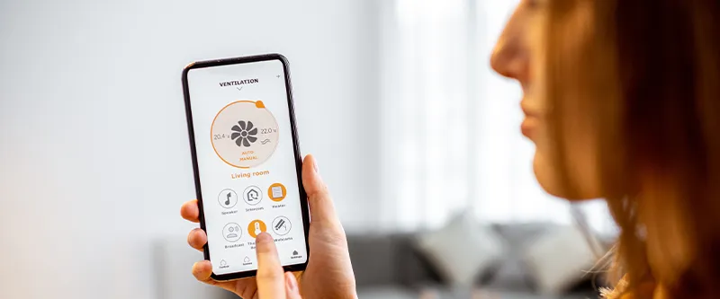 A woman using an HVAC app on her phone