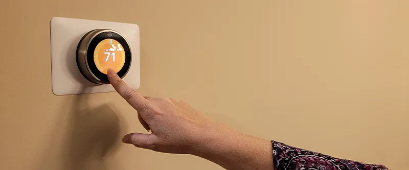 Closeup of a NEST thermostat on a wall