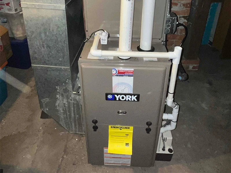A York furnace and air conditioning evaporator coil. The condensate drain piping is straight and expertly installed.