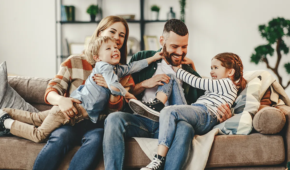 A happy family on the couch enjoying having the power on